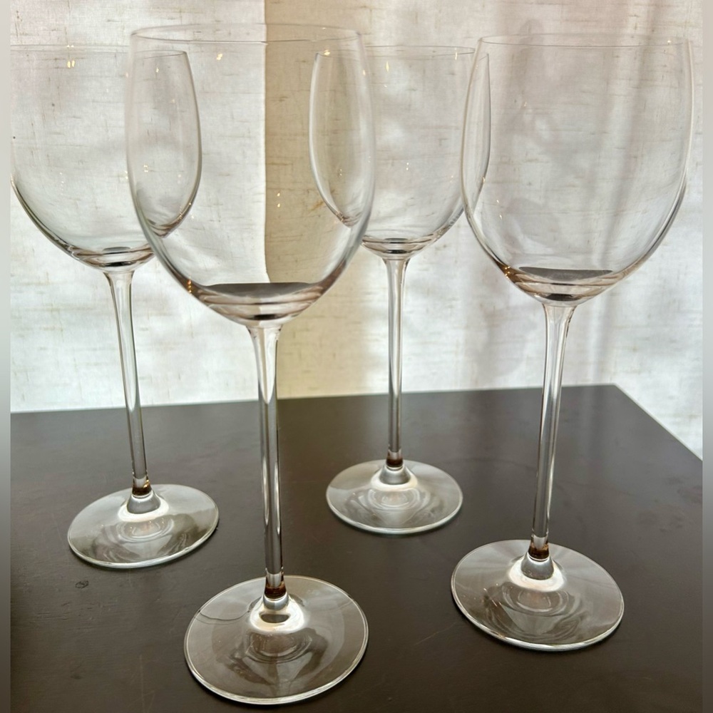 4 tall, fine glass wine glasses.